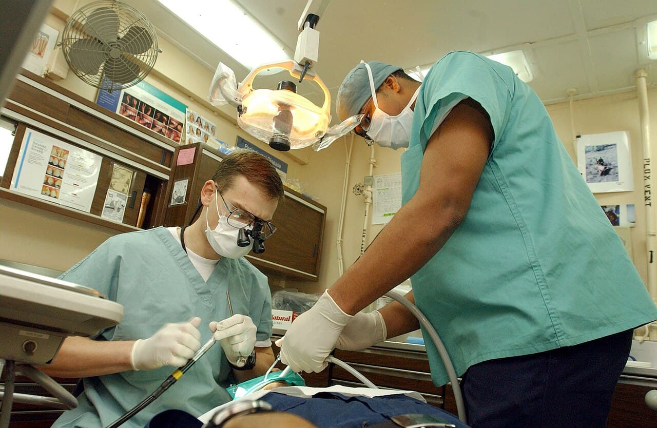 A dentist performing a check-up on a patient in a dental chair